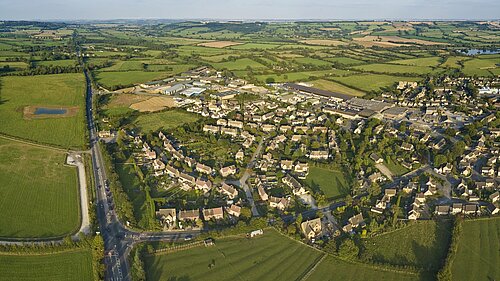 An aerial view of a village in the countryside.