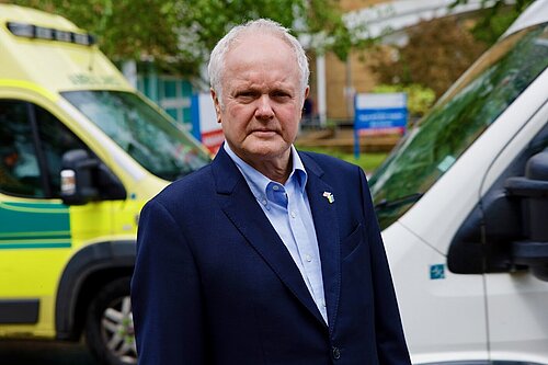 Clive Jones in front of an ambulance
