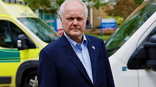 Clive with an ambulance in the background