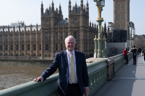 Clive on Westminster Bridge with Houses of Parliament in background. 