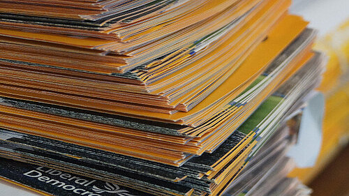 A bundle of leaflets atop a table