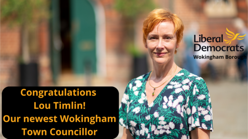 Lou Timlin outside Wokingham Town hall, Lib Dem logo and words "Congratulations Lou Timlin, our newest Wokingham Town Councillor